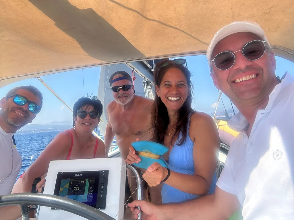 Fabrizio with guests at the helm of Grace
