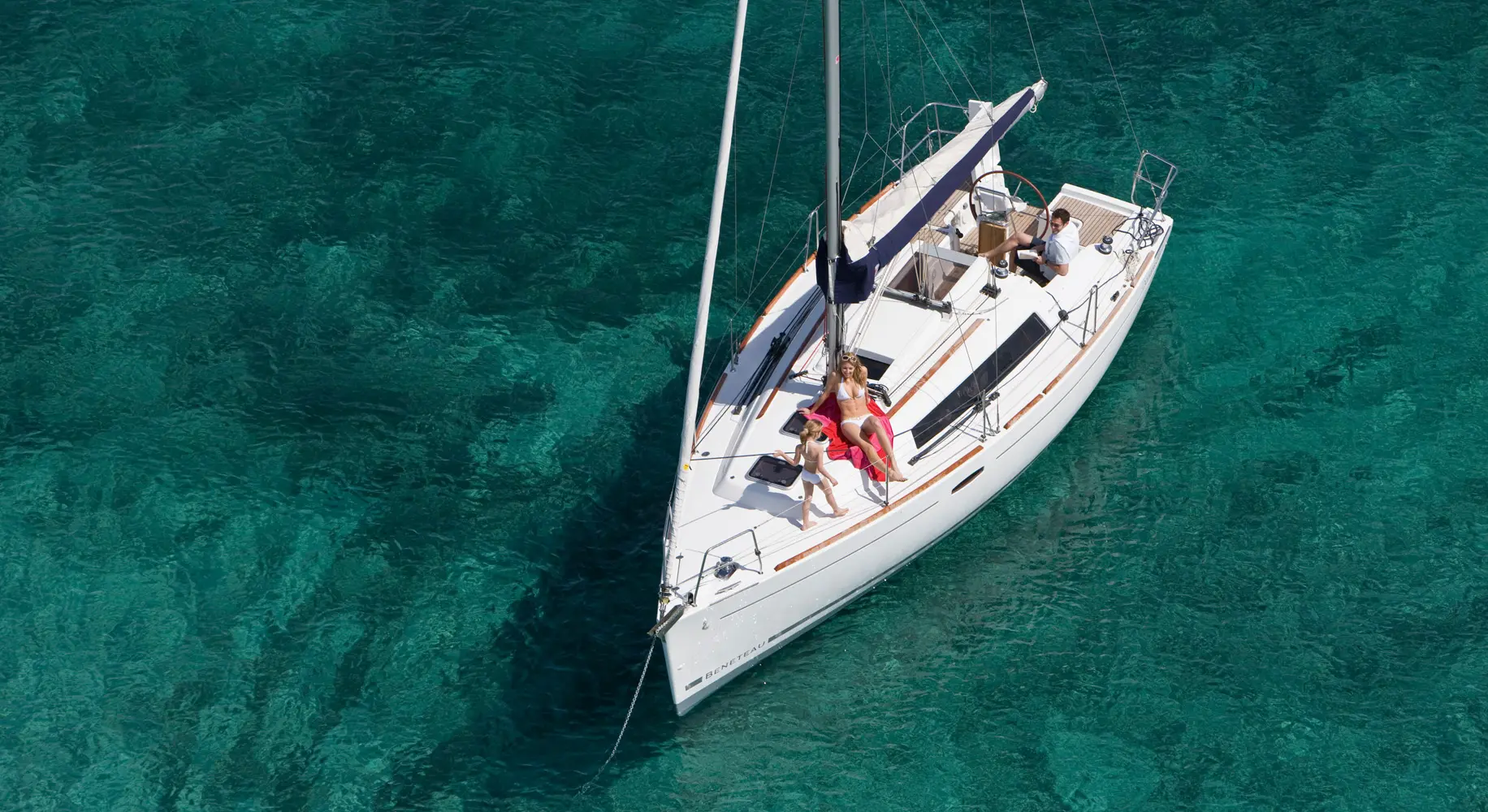 Grace sailing over clear turquoise water in Sicily